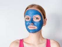 De mooie blondevrouw die blauw klei gezichtsmasker hebben is door schoonheidsspecialist van toepassing stock afbeeldingen De mooie blondevrouw die blauw klei gezichtsmasker hebben is door schoonheidsspecialist van toepassing stock afbeeldingen