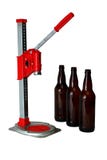 De Pers en de Flessen van Kroonkurk voor Huis brouwen Bier stock fotografie De Pers en de Flessen van Kroonkurk voor Huis brouwen Bier stock fotografie