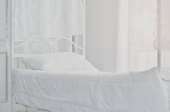 In de slaapkamer is er een wit bed royalty-vrije stock fotografie In de slaapkamer is er een wit bed royalty-vrije stock fotografie