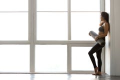 De slanke sportieve aantrekkelijke yoga of geschiktheid ma van de vrouwen bevindende holding royalty-vrije stock afbeeldingen De slanke sportieve aantrekkelijke yoga of geschiktheid ma van de vrouwen bevindende holding royalty-vrije stock afbeeldingen