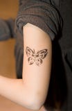 De Tatoegering van het jonge geitje stock foto's De Tatoegering van het jonge geitje stock foto's
