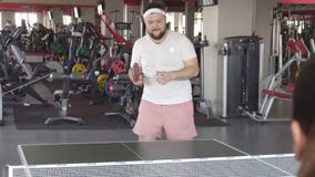 De vette gebaarde Kaukasische mens speelt pingpong en voert de sprongoefening voor gezond gewichtsverlies uit, stock video De vette gebaarde Kaukasische mens speelt pingpong en voert de sprongoefening voor gezond gewichtsverlies uit, stock video