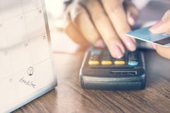 Deadline calendar note with blur background of business woman hand counting her debt on calculator with hand holding credit card stock images Deadline calendar note with blur background of business woman hand counting her debt on calculator with hand holding credit card stock images