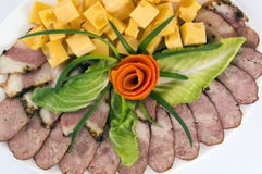 Decoration of meat cuts of sausage, bacon and cheese, greens royalty free stock photos Decoration of meat cuts of sausage, bacon and cheese, greens royalty free stock photos