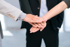 Dedicated team. Business people putting their hands together in sign of trust and unity Dedicated team. Business people putting their hands together in sign of trust and unity