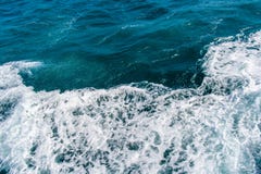Deep blue stormy sea water surface with white foam and waves pattern. Background photo texture Royalty Free Stock Photography Deep blue stormy sea water surface with white foam and waves pattern. Background photo texture Royalty Free Stock Photography