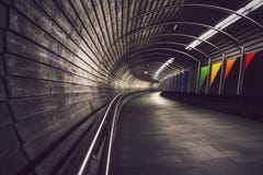 Deep perspective into dark, winding underground tunnel