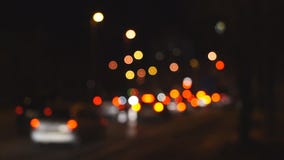 Defocused night traffic in city. Colored stains on the background Defocused night traffic in city. Colored stains on the background