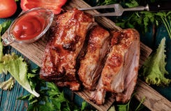 Delicious barbecued ribs seasoned with a spicy basting sauce stock images Delicious barbecued ribs seasoned with a spicy basting sauce stock images