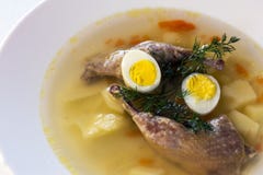 Delicious fragrant soup based on quail broth in a white dining plate. Slices of meat, quail egg, dill, bulgur, pepper and crackers royalty free stock photo Delicious fragrant soup based on quail broth in a white dining plate. Slices of meat, quail egg, dill, bulgur, pepper and crackers royalty free stock photo