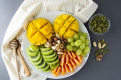 Delicious Fruits Platte Isolated. Mango, Kiwi, Citrus, Nuts, Grapes. Mix Of Various Exotic Fruits. Healthy Fruit Salad Royalty Free Stock Photos