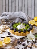 Delicious homemade lemon tart. Pie on rustic white table. Tart with blackberry and meringue royalty free stock image Delicious homemade lemon tart. Pie on rustic white table. Tart with blackberry and meringue royalty free stock image