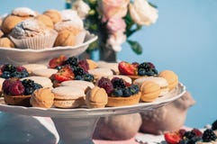 Delicious sweet buffet with cupcakes, macaroons, other desserts, blue design stock image Delicious sweet buffet with cupcakes, macaroons, other desserts, blue design stock image