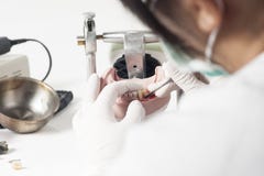 Dental technician working with articulator royalty free stock photos Dental technician working with articulator royalty free stock photos