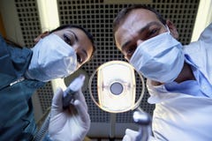 Dentist And Assistant Working And Filling Tooth To Sick Patient Royalty Free Stock Photos Dentist And Assistant Working And Filling Tooth To Sick Patient Royalty Free Stock Photos