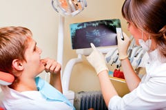 Dentist explaining the details of a x-ray picture