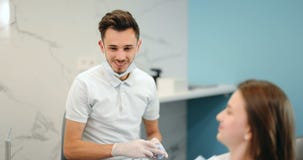 Dentist showing jaw model for a young patient