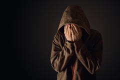 Depressive man in hooded jacket is crying Royalty Free Stock Image Depressive man in hooded jacket is crying Royalty Free Stock Image