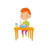 Der nette rothaarige Junge, der bei Tisch sitzt und seine Frühstück Schüssel Corn Flakes isst, schellt mit Milch und Glas der Ora stock abbildung Der nette rothaarige Junge, der bei Tisch sitzt und seine Frühstück Schüssel Corn Flakes isst, schellt mit Milch und Glas der Ora stock abbildung