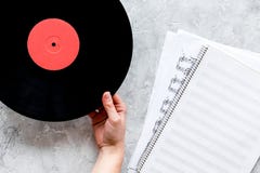 Desk of musician or dj with vynil records and blank paper for songwriter work on stone background top view mockup. Desk of musician or dj with vynil records and royalty free stock photo Desk of musician or dj with vynil records and blank paper for songwriter work on stone background top view mockup. Desk of musician or dj with vynil records and royalty free stock photo