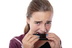 Desperate young woman bites in her smart phone Stock Photography Desperate young woman bites in her smart phone Stock Photography