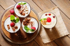 Dessert with berries, jelly, cream, nuts and mint leaf on a cutting wooden board Royalty Free Stock Photos Dessert with berries, jelly, cream, nuts and mint leaf on a cutting wooden board Royalty Free Stock Photos
