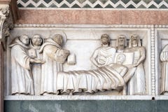 Bass-relief representing the Stories of St. Martin, Cathedral of St. Martin in Lucca, Italy stock photo Bass-relief representing the Stories of St. Martin, Cathedral of St. Martin in Lucca, Italy stock photo