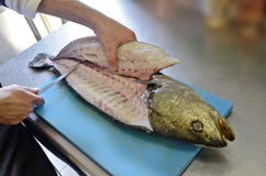 Details filleting fish on a cutting board