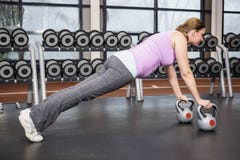 Determined woman planking with kettlebells royalty free stock photo Determined woman planking with kettlebells royalty free stock photo