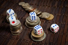 Dice and coins of different countries on a dark background royalty free stock photo Dice and coins of different countries on a dark background royalty free stock photo