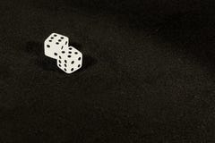 Dice on the table on a black background. stock photos Dice on the table on a black background. stock photos