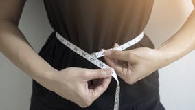 Diet concept close up women measuring waist circumference. stock photography Diet concept close up women measuring waist circumference. stock photography