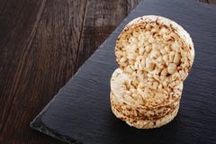 Diet Rice Cakes Pile On Dark Piece Of Board On The Wooden Table, Selective Focus. Royalty Free Stock Photos