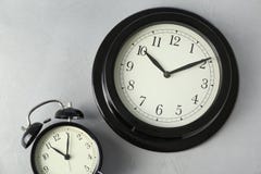 Different clocks on light background. Time change royalty free stock image Different clocks on light background. Time change royalty free stock image