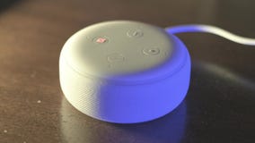 White Amazon Alexa Echo Dot 3rd Generation with different light colors effects..