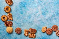Different types of bisquits as a frame on vintage background stock photo Different types of bisquits as a frame on vintage background stock photo