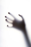 Diffused shadow of hand with thin fingers behind the frosted glass Royalty Free Stock Photos Diffused shadow of hand with thin fingers behind the frosted glass Royalty Free Stock Photos