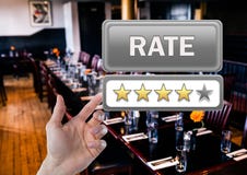 Hand pointing at Rate button and star reviews in restaurant royalty free stock photography Hand pointing at Rate button and star reviews in restaurant royalty free stock photography