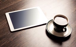 Digital tablet computer with cup of coffee on old wooden desk royalty free stock image Digital tablet computer with cup of coffee on old wooden desk royalty free stock image