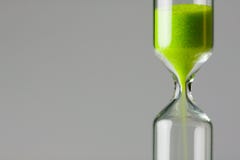 Diminishing green. Green sand of hour glass