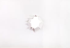 Direct view of sheet of paper with punched hole stock photos Direct view of sheet of paper with punched hole stock photos