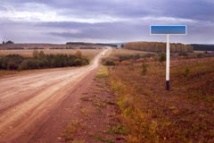 Dirt Road And Road Sign Royalty Free Stock Image