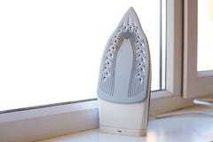 Dirty iron on the white window sill. royalty free stock images Dirty iron on the white window sill. royalty free stock images