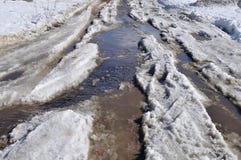Dirty Snow Road With Puddle In Early Spring Stock Images