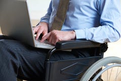 Disabled Businessman In Wheelchair Using Laptop stock photos Disabled Businessman In Wheelchair Using Laptop stock photos
