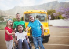 Disabled girl in wheelchair with friends in front of school bus stock image Disabled girl in wheelchair with friends in front of school bus stock image