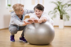 Disabled woman exercising on the ball with physiotherapist royalty free stock photo Disabled woman exercising on the ball with physiotherapist royalty free stock photo