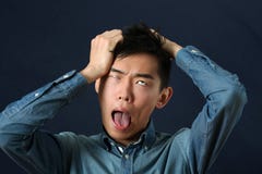 Disappointed Asian man making face and rolling eyes up royalty free stock photo Disappointed Asian man making face and rolling eyes up royalty free stock photo