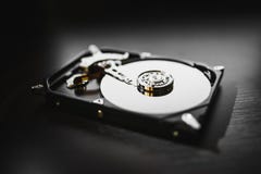 Disassembled hard drive from the computer (hdd) with mirror effects. Part of computer (pc, laptop) stock photos Disassembled hard drive from the computer (hdd) with mirror effects. Part of computer (pc, laptop) stock photos