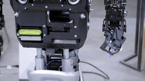 Disassembled robot in production. The robot is ready for assembly, raises his hand. Plant for the production of robots. stock video footage Disassembled robot in production. The robot is ready for assembly, raises his hand. Plant for the production of robots. stock video footage